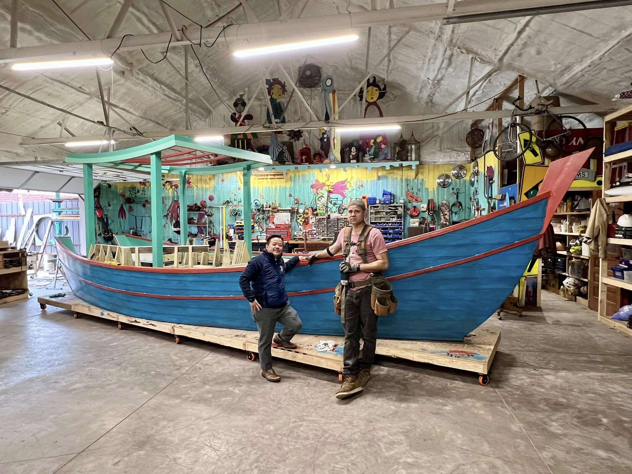 Three quarter view of the painted Vietnamese Refugee Boat with Toon H Nguyen and Gabriel Friedman