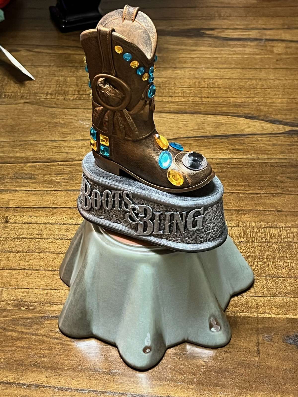 Birthday lady proudly displaying her Boots & Bling gift on a stand
