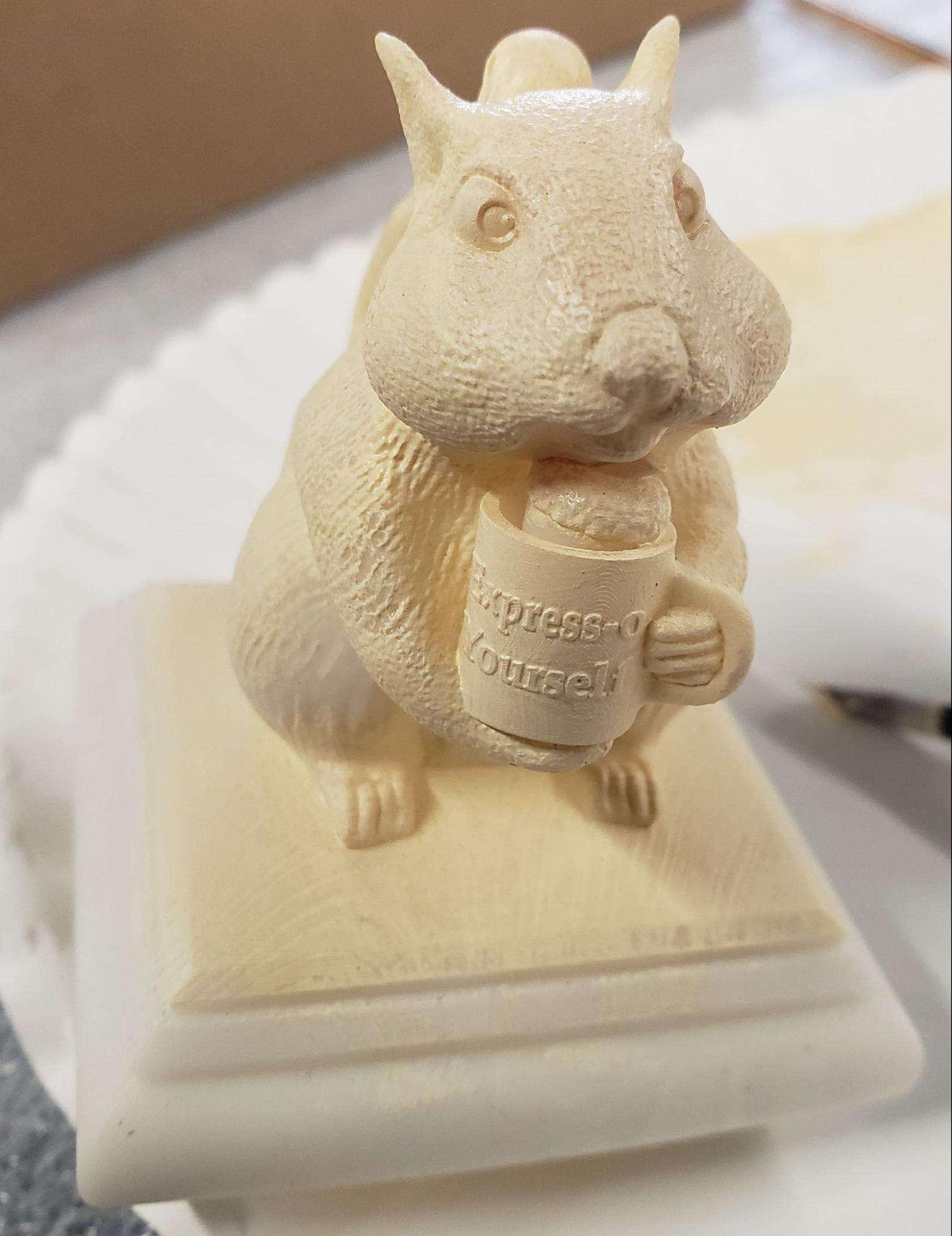 3D Printed squirrel cap being painted in white
